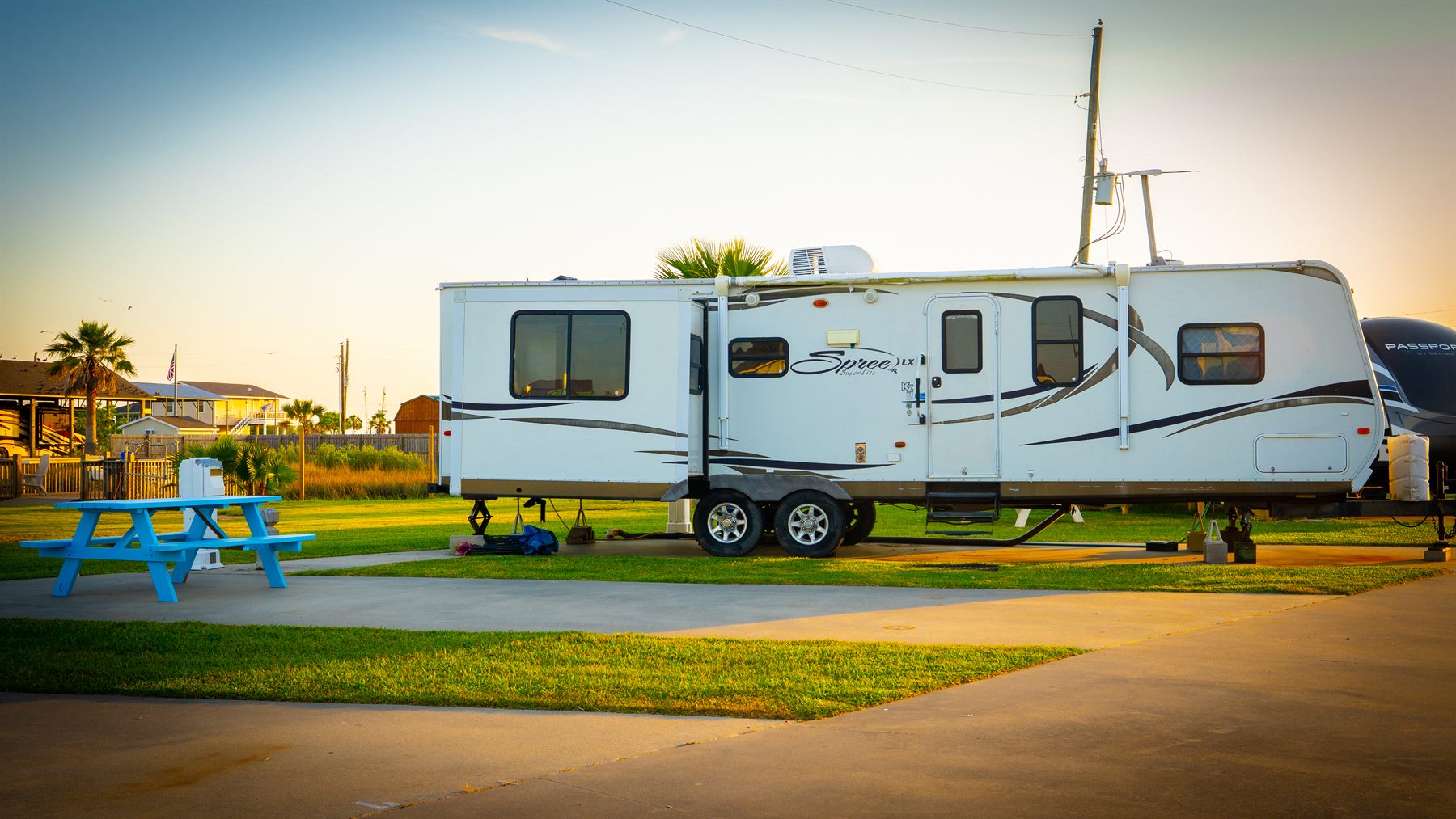 RV site with concrete pad and picnic table at The Palms RV Resort