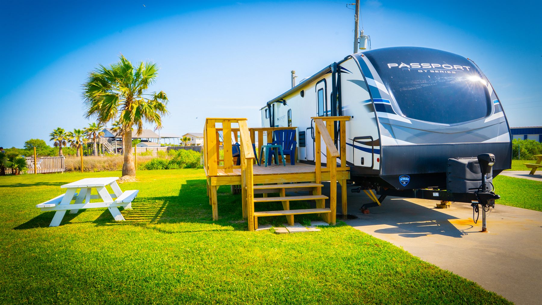 RV site with palm tree and concrete pad near Crystal Beach